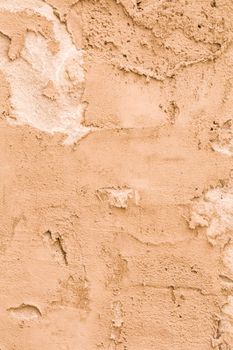 Rough plaster wall Brown with obvious divorces on the surface.