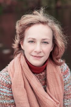 portrait of a young beautiful girl with developing hair in an autumn sweater. High quality photo