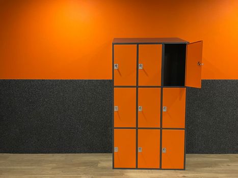 dressing room in the gym with orange-gray cement walls locker room for athletes. High quality photo