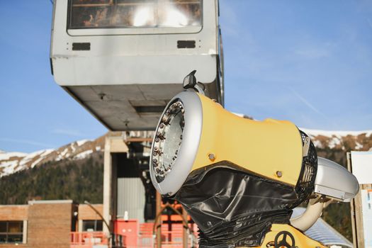 Snow gun in the mountains and cable car