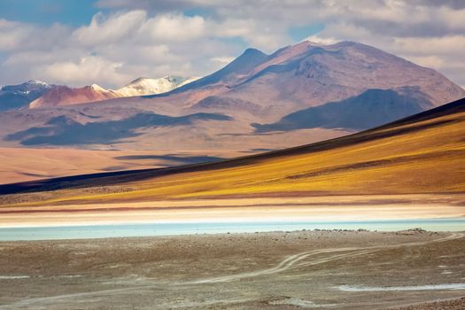 Salt lake reflection and idyllic volcanic landscape at Sunset, Atacama desert, Chile border with Bolivia