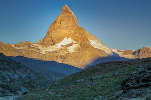 Majestic Matterhorn with golden light at sunrise, Swiss Alps, Zermatt, Switzerland
