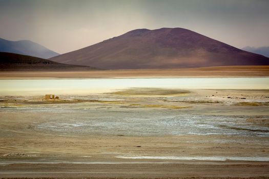 Salt lake reflection and idyllic volcanic landscape at Sunset, Atacama desert, Chile border with Bolivia