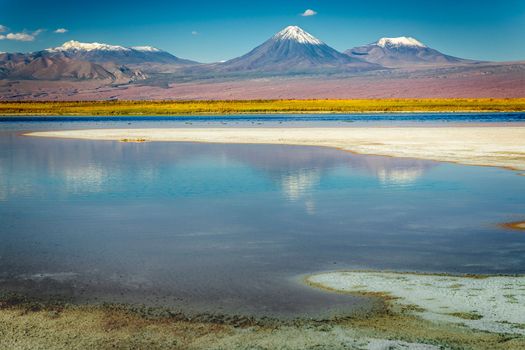 Licancabur and Peaceful reflection lake with dramatic volcanic landscape at Sunset, Atacama Desert, Chile