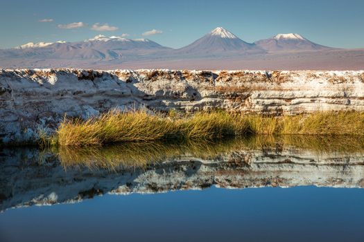 Licancabur and Peaceful reflection lake with dramatic volcanic landscape at Sunset, Atacama Desert, Chile