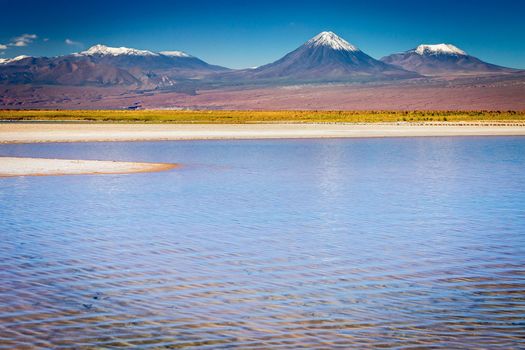 Licancabur and Peaceful reflection lake with dramatic volcanic landscape at Sunset, Atacama Desert, Chile