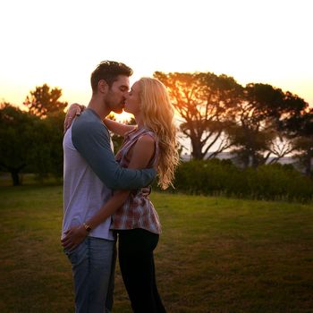 Cant get enough of your kisses. an affectionate young couple sharing a kiss at sunset