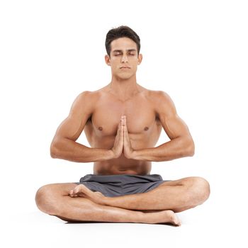Getting rid of daily stress. A handsome young man doing yoga on a white background