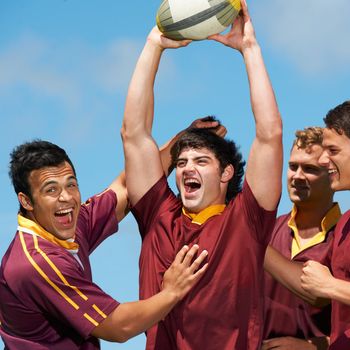 The faces of winners. a young rugby team celebrating a victory