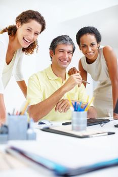 Business people with an attractive smile. Portrait of business people sitting at a table and giving you an attractive smile