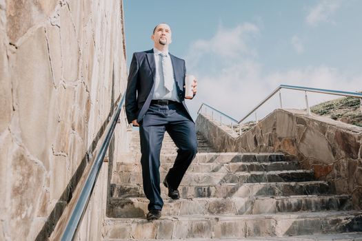 Business executive with briefcase going down the stairs.