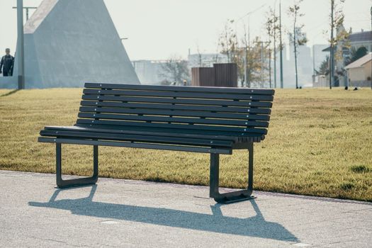 Sea side public park with concreate bench in spring evening.