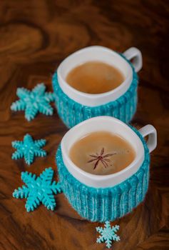 Coffee in cups with cardamom and white sugar on vintage wooden background