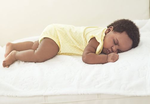 Babies need lots of rest. a baby girl asleep on a bed at home