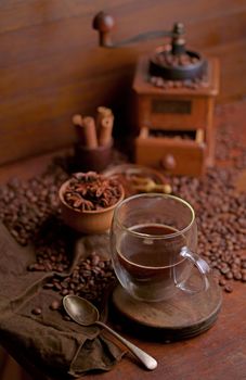 Tasty steaming espresso in cup with coffee beans. View from above.