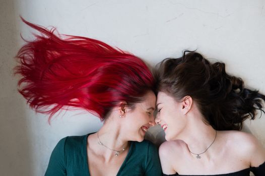 Top view of two women lying side by side. Lesbian intimacy