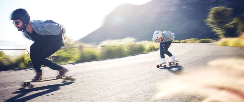 Sports, speed and fast longboard skating in road, friends racing downhill with skateboard and helmet for safety. Extreme sport adventure, skateboarding street race and skateboarder on mountain pass