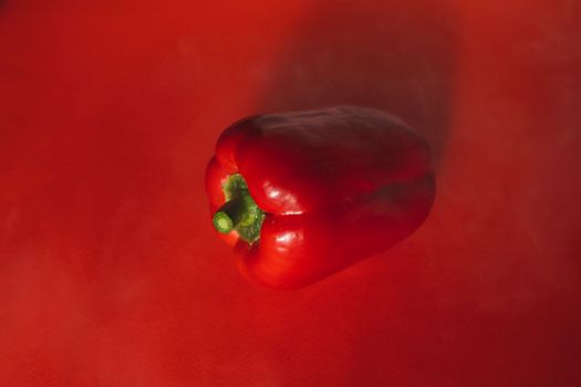 SWEET PEPPER ON A RED BACKGROUND.