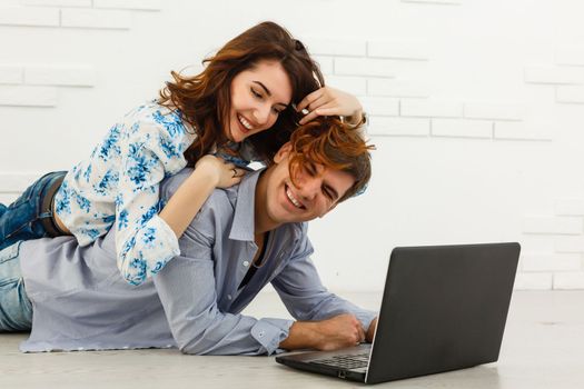 Couple buying online together with a laptop on a desktop at home