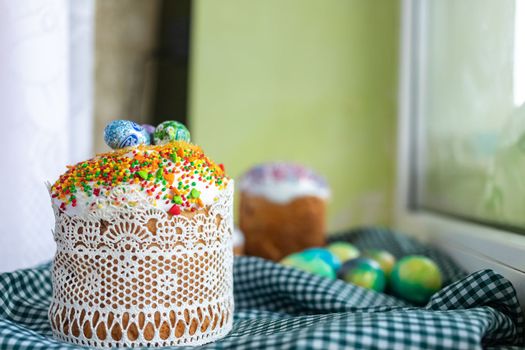 Easter cake with glace icing and easter eggs on black background.