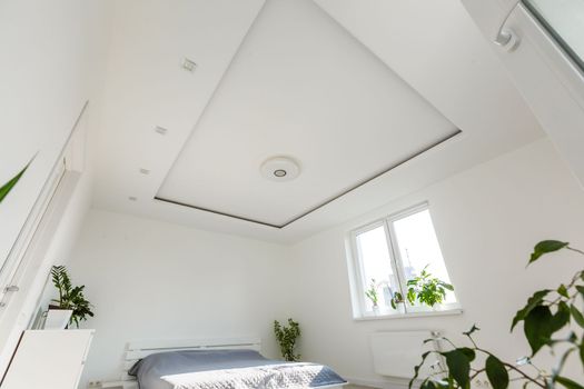 Abstract white waving curtain in white bedroom apartment