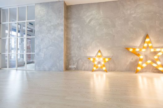 Decorative star with lamps on a background of wall. Modern grungy interior