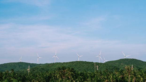 Windmills row Beautiful day time clear blue blue sky Vietnam green mountain tropical palm trees Natural landscape.