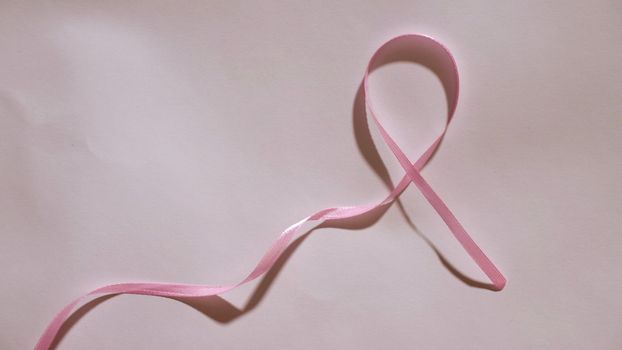Breast Cancer disease symbol with pink ribbon on white background close-up on world Cancer Awareness Day 4 February