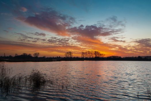 Colorful clouds after sunset over calm lake, Stankow, Lubelskie, eastern Poland