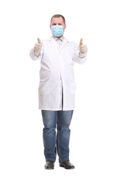 Doctor wearing a surgical mask against infections standing with crossed arms in a lab coat isolated on white in a corona virus or Covid-19 concept