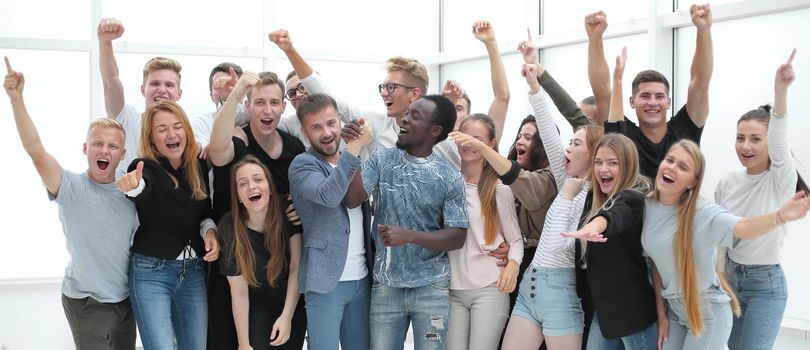 team of happy young people showing their success. photo with copy space