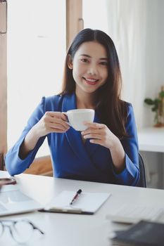 Smiling and happy asian businesswoman looking at camera. Finance and Accounting concept