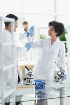 Team of Scientists Working Using Microscope, Analysing Microbiology Samples