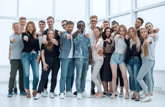 group of happy young men pointing at you. photo with copy space