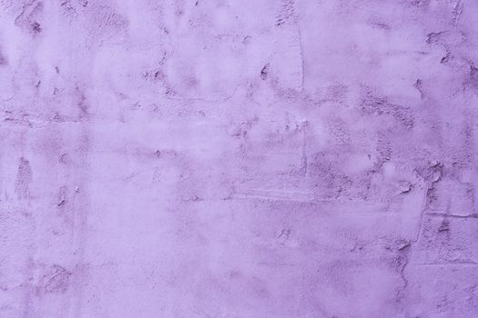 The surface of the old uneven purple plaster. Purple cement wall.