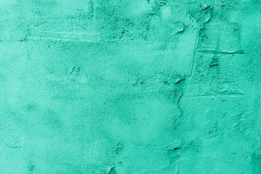 Plaster textured background. Blurred photo. Cement wall painted with green paint.