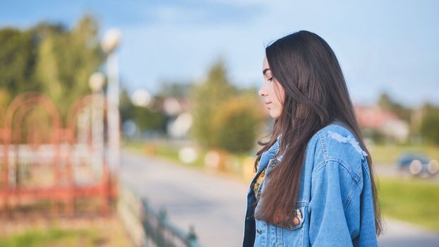 Portrait of a lonely girl by a lake