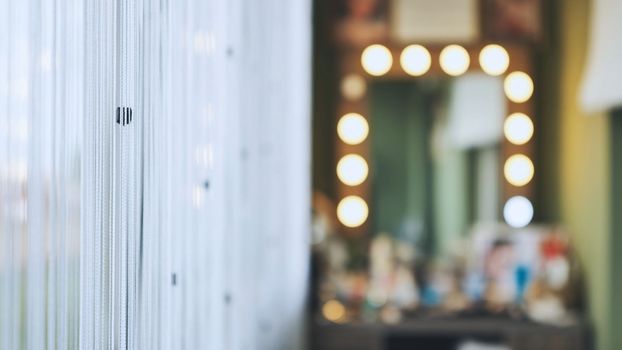 The makeup artist's office against a backdrop of curtains