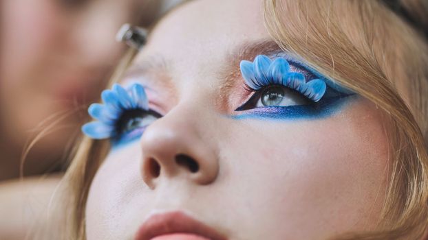 Original makeup for the model. Flower petals on the lashes