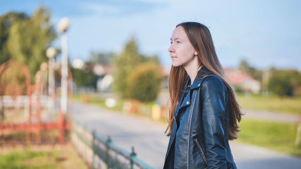 Portrait of a lonely girl by a lake