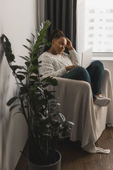 African american young woman using laptop on bed - technologies and communication and social network