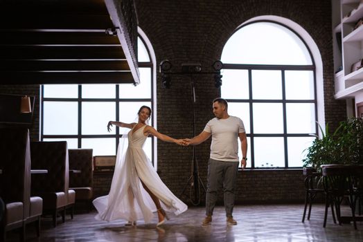 young couple the groom in a blue suit and the bride in a white dress on a walk