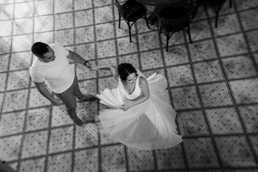 young couple the groom in a blue suit and the bride in a white dress on a walk