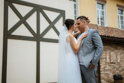 young couple the groom in a blue suit and the bride in a white dress on a walk