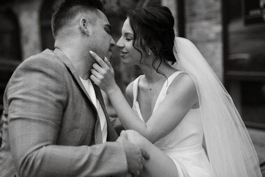 young couple the groom in a blue suit and the bride in a white dress on a walk