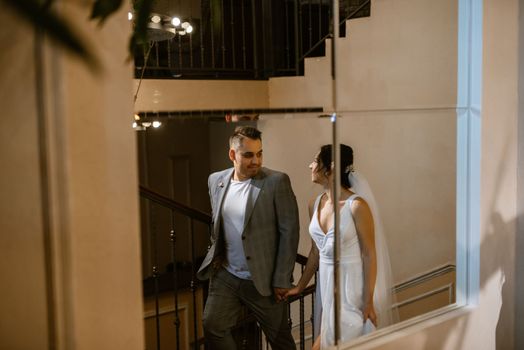 young couple the groom in a blue suit and the bride in a white dress on a walk