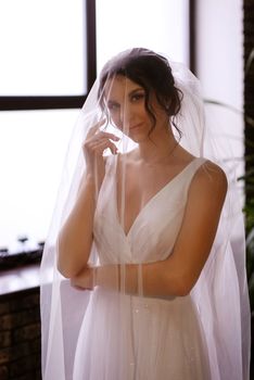 preparations for the bride with the dressing of the wedding dress in the studio