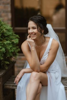 preparations for the bride with the dressing of the wedding dress in the studio