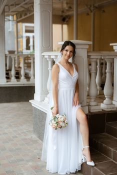 preparations for the bride with the dressing of the wedding dress in the studio