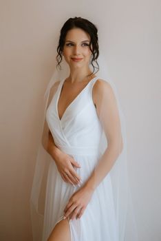 preparations for the bride with the dressing of the wedding dress in the studio